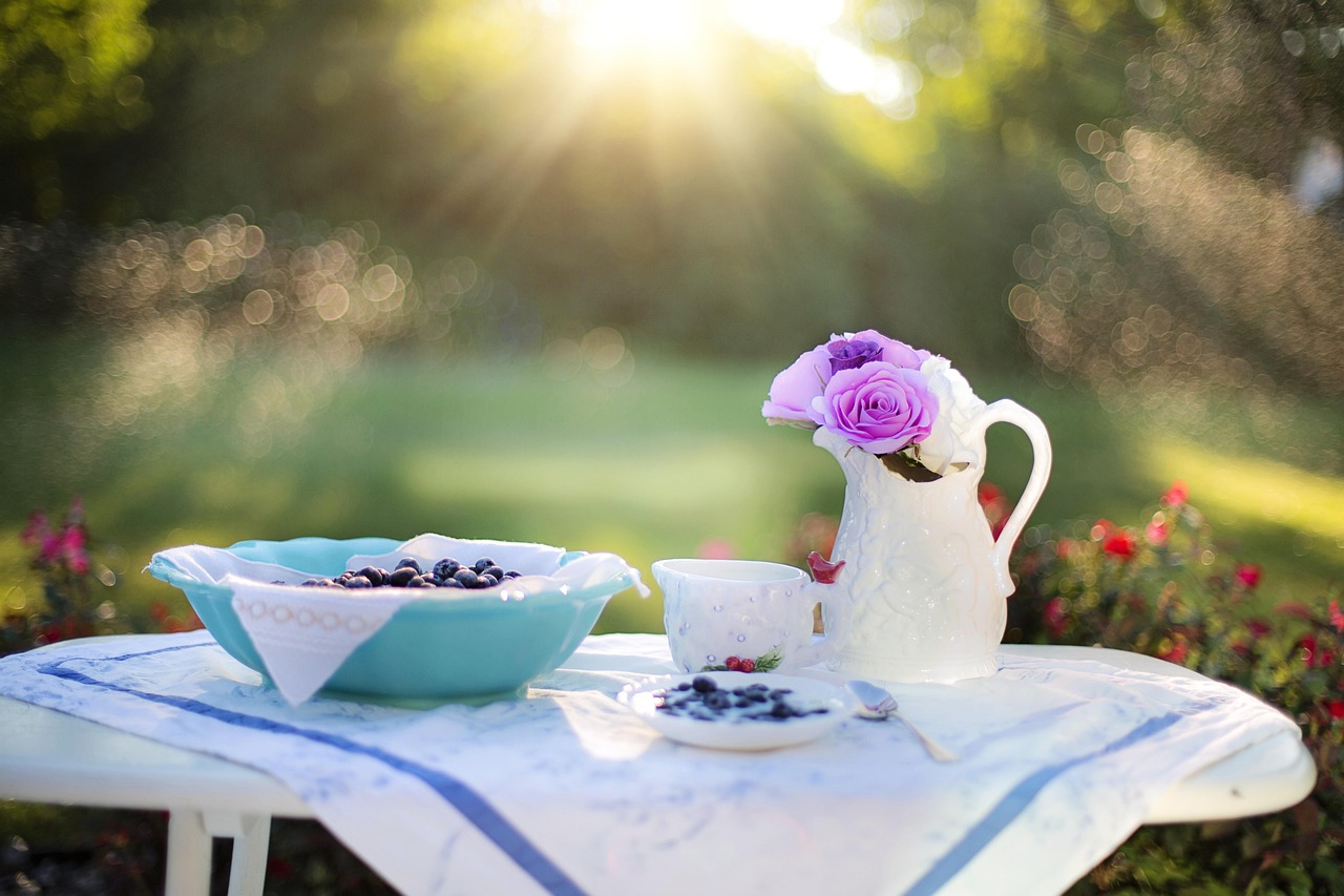 A person serving a slice of healthy strawberry shortcake at an outdoor table