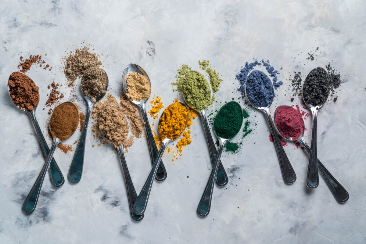 Selection of different colored nutritional powders illustrating the range of health benefits from gut health to energy.