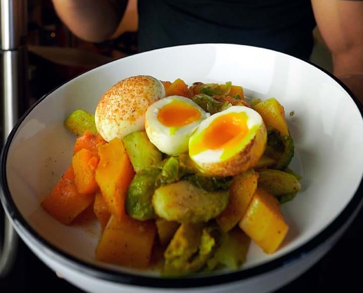 Detailed view of zesty lime avocado mash topped with golden roasted chickpeas and pepitas.