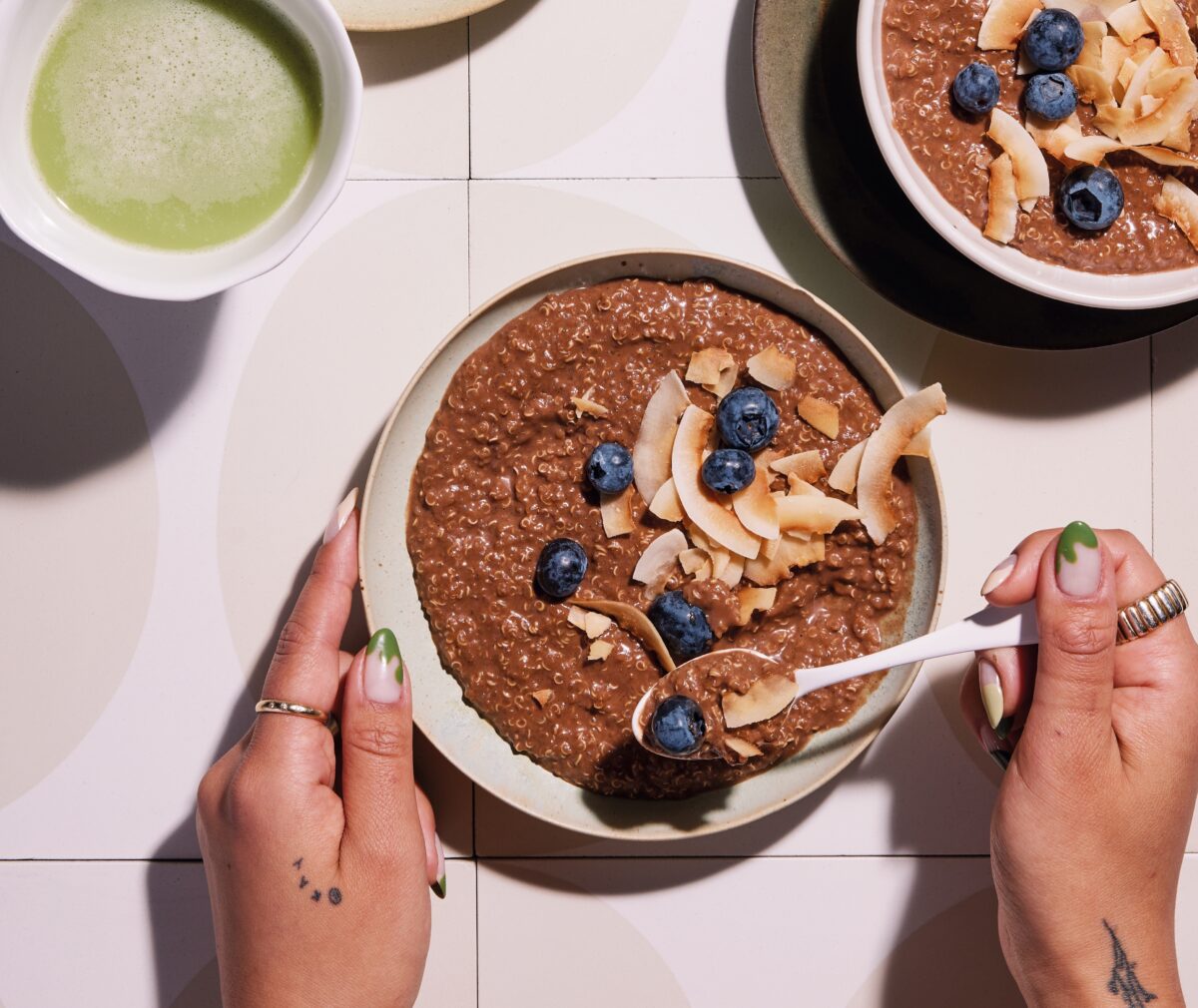 A close-up shot of a rich chocolate quinoa breakfast bowl with fresh berries.
