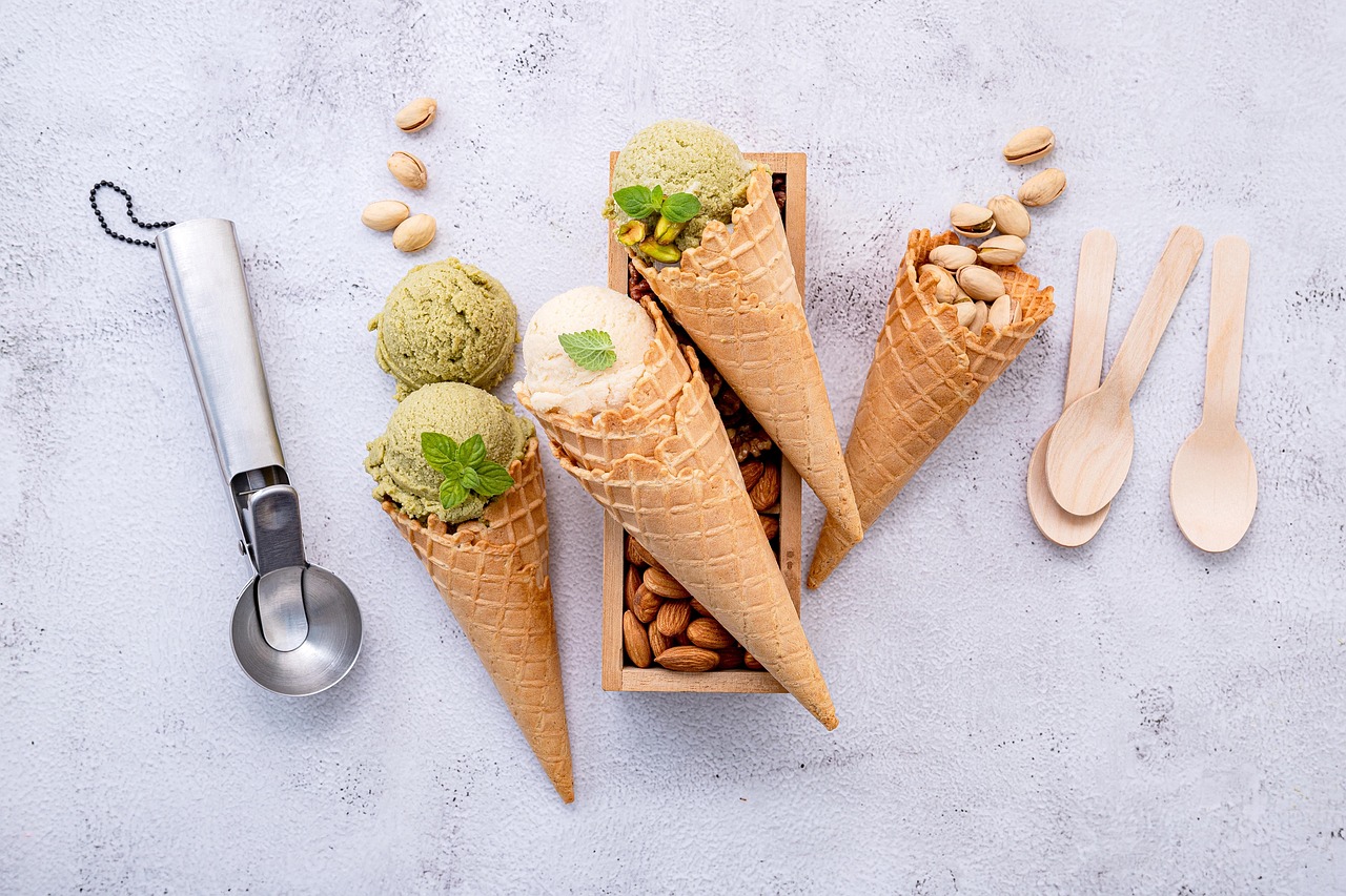Creamy nut butter, raw walnuts, and hemp seeds arranged on a kitchen table.
