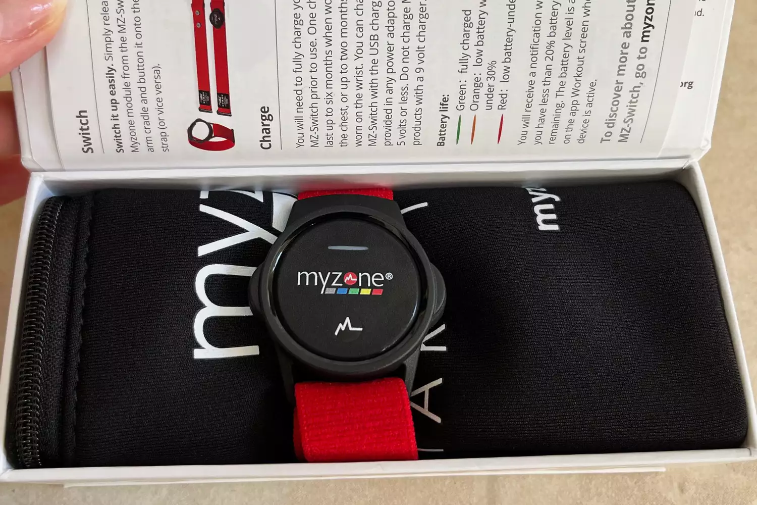 The MyZone MZ-Switch heart rate monitor in its retail packaging showing the sensor and strap components.