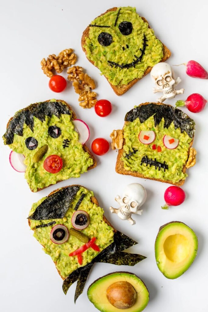 Orange bell peppers carved with jack-o-lantern faces and stuffed with quinoa and beans.