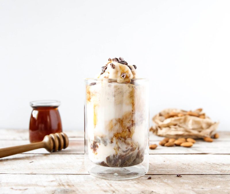 Frothy iced almond milk coffee highlighting its creamy consistency.