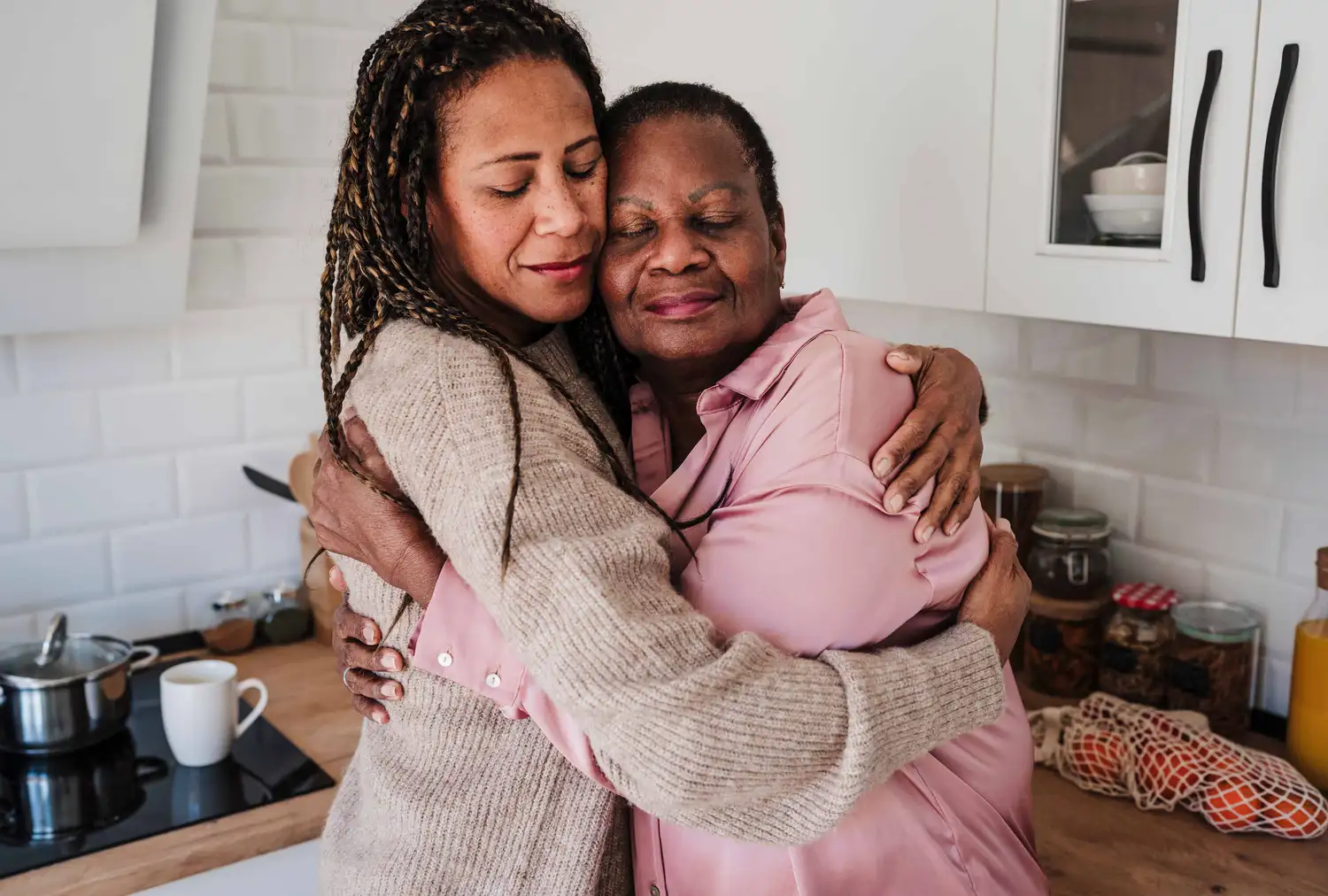 A mother and daughter hugging, symbolizing the bond and the importance of sharing family health history.
