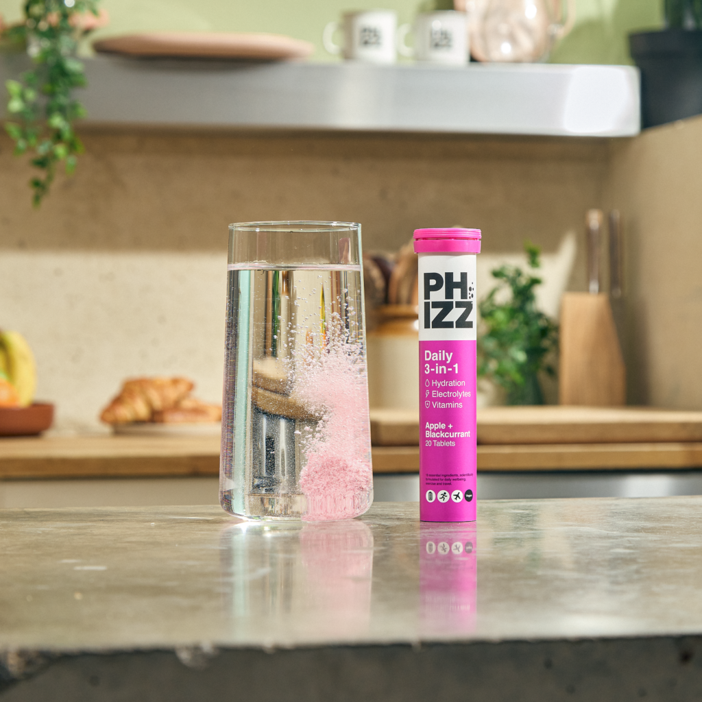 Close-up of Phizz effervescent tablets and portable tube packaging.