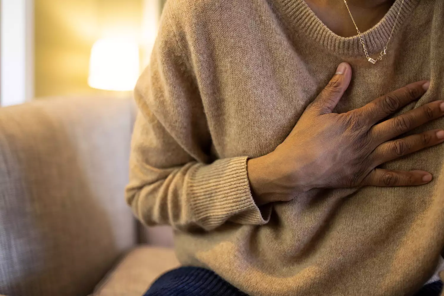 A woman appearing concerned while touching her chest, symbolizing the importance of monitoring health signals.