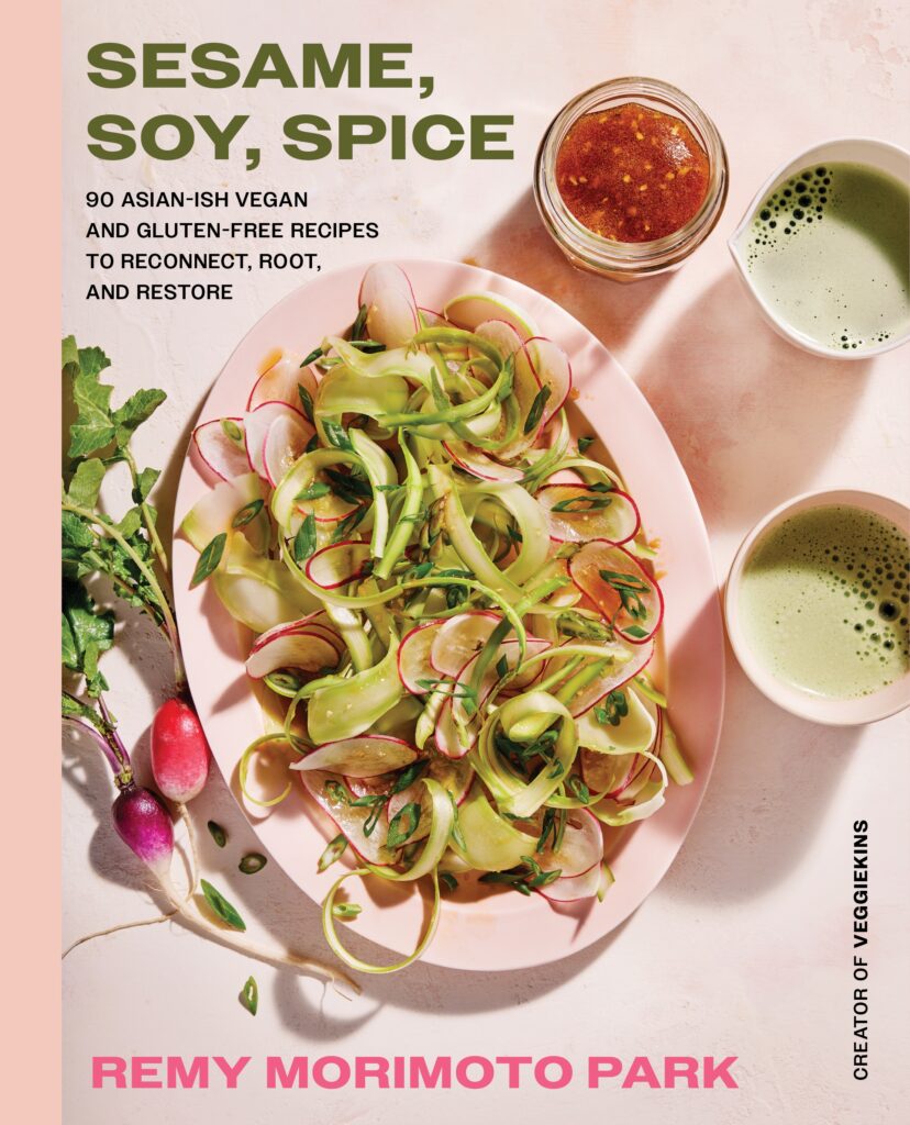 A colorful appetizer spread featuring edamame dip surrounded by sliced cucumbers, radishes, and tamari rice crackers.