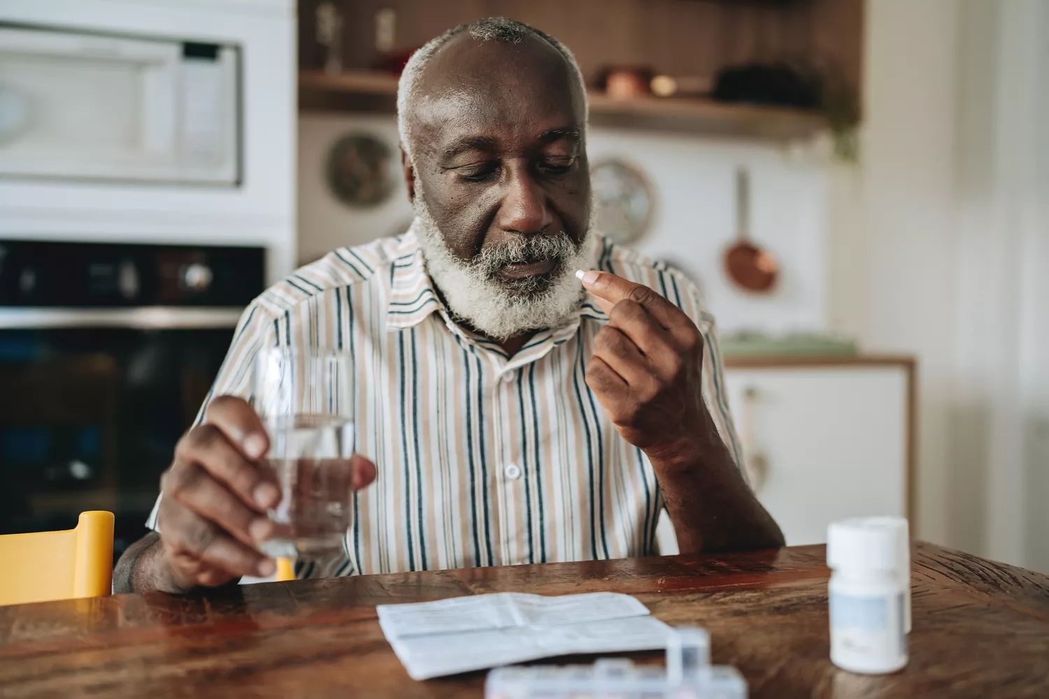 A person handling medication related to their weight loss treatment plan.