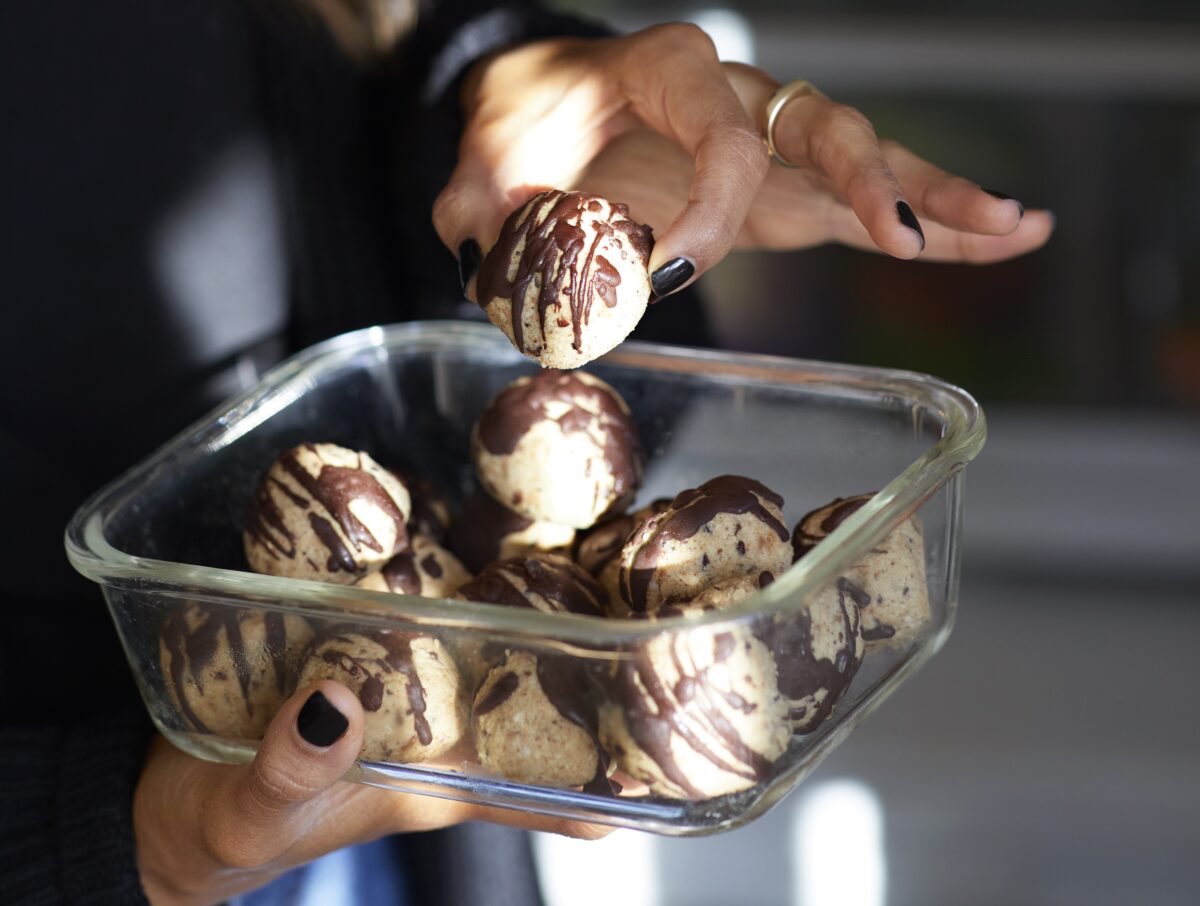 Close-up of salted chocolate chip protein bites made with cashew butter and millet flakes.
