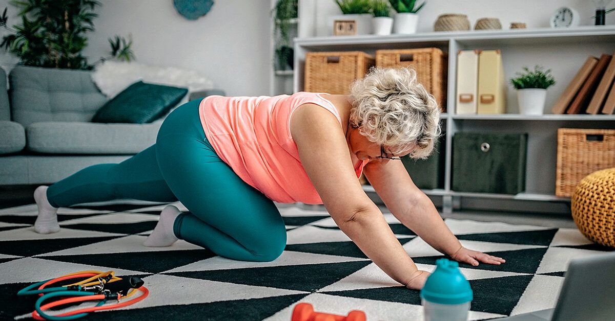 Close-up of a person performing a compound bodyweight exercise on a floor.