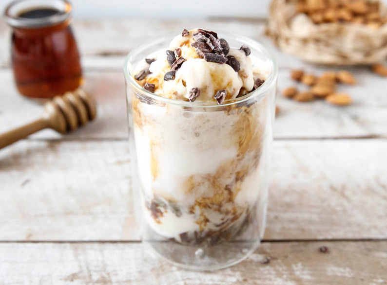 Close-up of a chilled almond milk iced coffee in a glass.