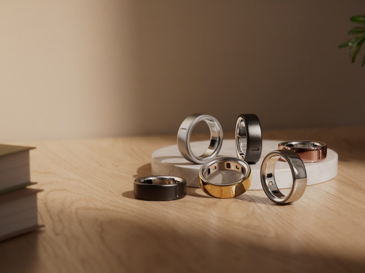 Close-up of the interior PPG sensors of a smart ring glowing with light.