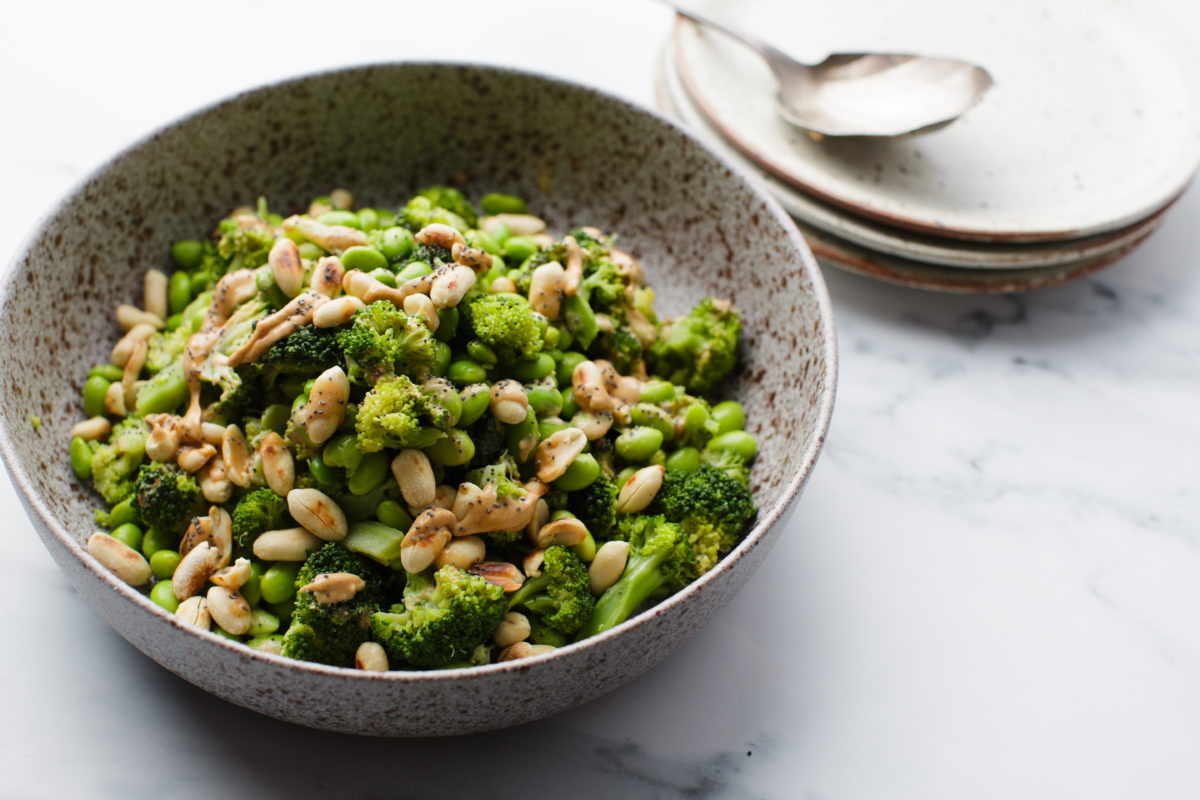 Close-up of Asian broccoli salad featuring vibrant green florets and protein-rich edamame.