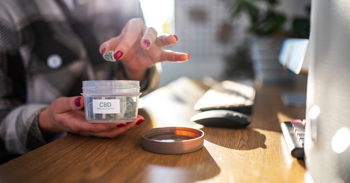 CBD gummies placed on a table alongside wellness supplements.