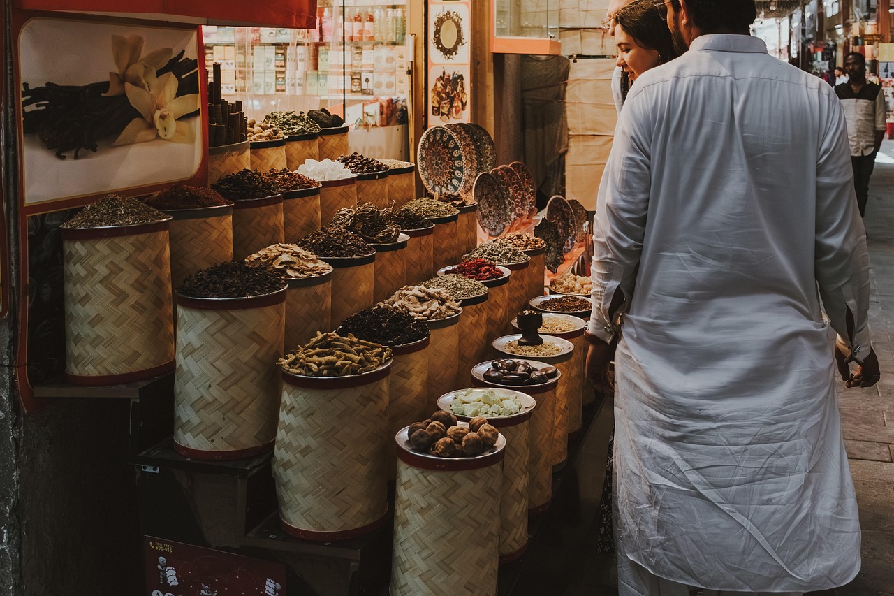 A collection of dried red guajillo chiles and Mexican spices in small bowls.