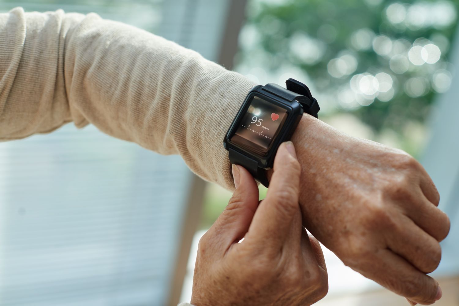 An older adult wearing a sleek fitness watch during active daily movement.
