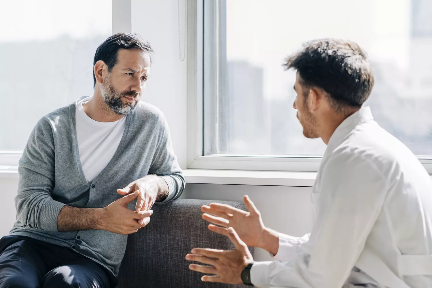 An athlete or individual talking with a healthcare provider about their health and recovery routine.