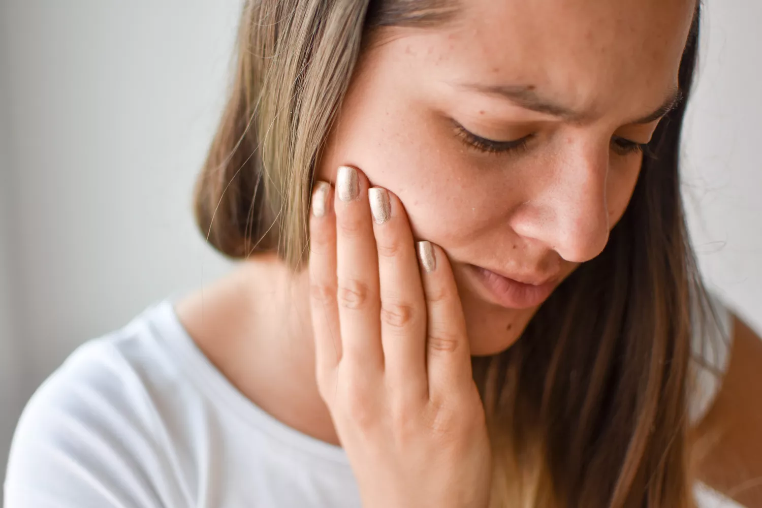 A person expressing mild physical discomfort during a medical testing procedure.