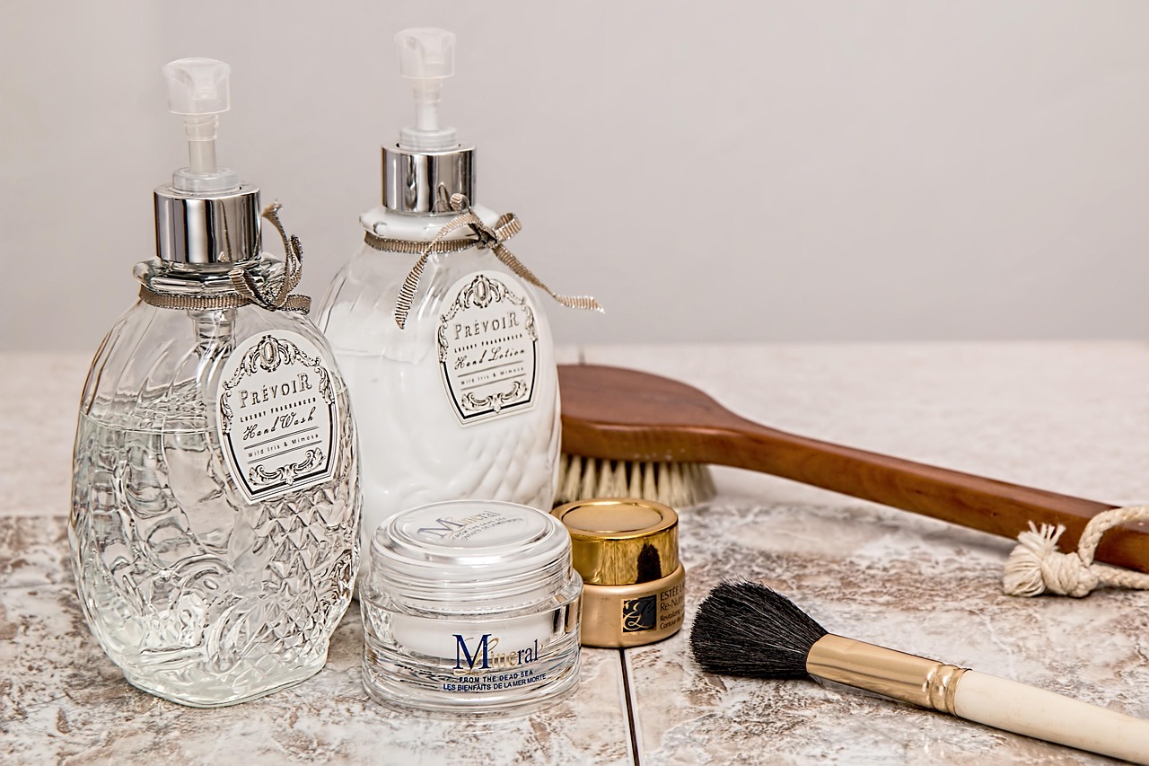 A minimalist bathroom shelf with a few high-quality skincare products and a towel