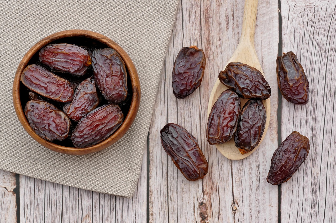 Macro shot of a wrinkled, plump Medjool date showing its soft texture.
