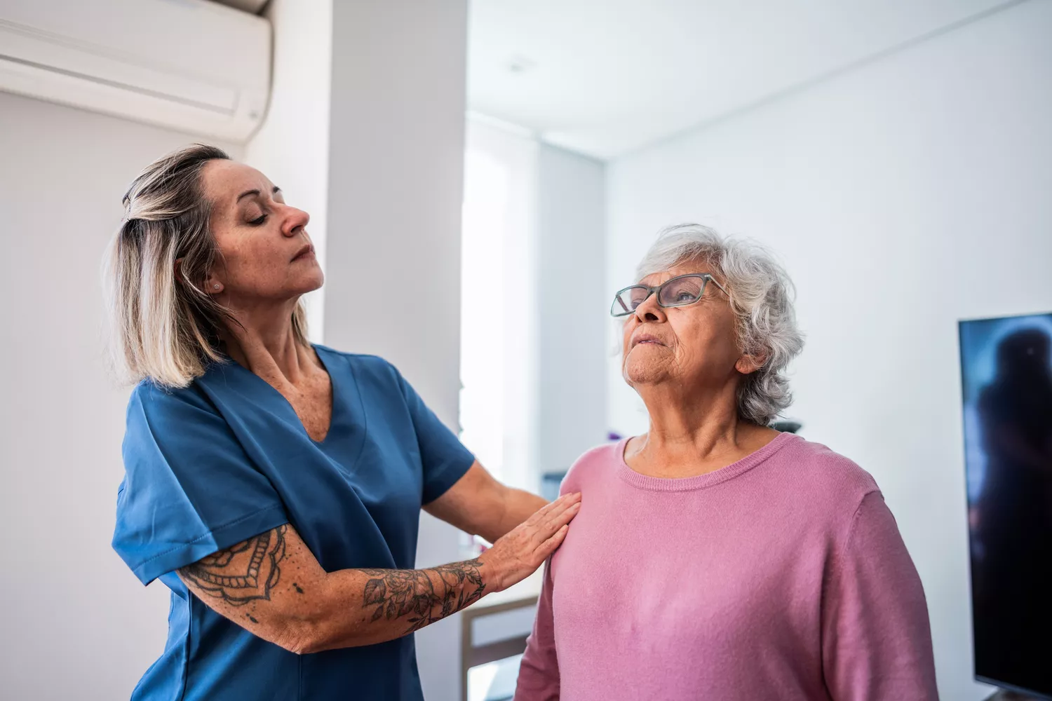 An older person practices postural exercises and nose breathing with a healthcare provider.