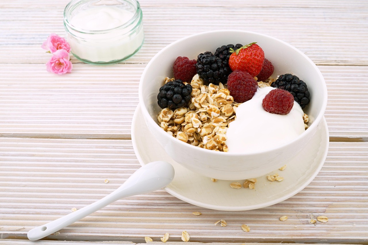 A breakfast bowl with Greek yogurt, fresh blueberries, and grain-free granola clusters